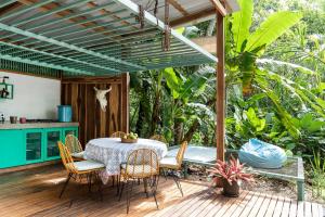 a patio with a table and chairs under a pergola at Amazing Cabin RIO LA MIEL in Estación El Salto
