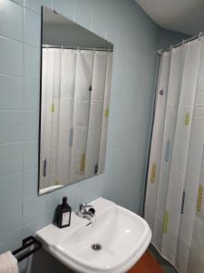 a white bathroom with a sink and a mirror at Piso El Comienzo in Puerto Real +14 photos