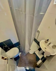 a bathroom with a toilet and a sink at Cozy apartment comfy 1 in Serres +20 photos