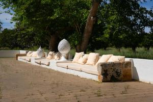 a long white couch sitting on top of a sidewalk at Tenuta Doxi in Gallipoli