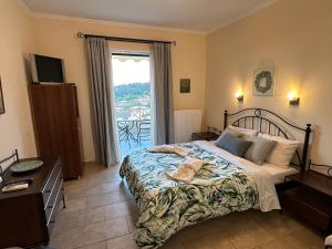 a bedroom with a bed and a large window at Iremia in Kariá