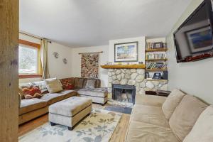 a living room with a couch and a fireplace at Ore House 8 in Frisco