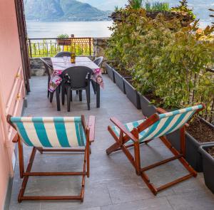 a patio with a table and chairs on a balcony at Rosa House Varenna in Varenna