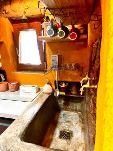 a kitchen with a stone sink in a kitchen at Borgo Castello Sidra SG in Giulianello