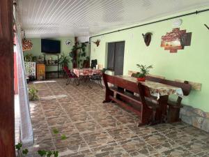 a living room with a bench and a table at Căsuța Verde in 2 Mai