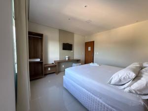 Giường trong phòng chung tại Pousada Allphaville