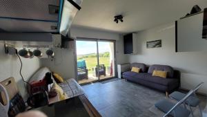 a living room with a couch and a table at Update Location in Lanester