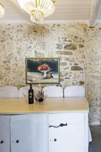 a painting of a bowl of fruit and a chandelier at Antonia's stonebuilt mansion with a private pool in Arménoi