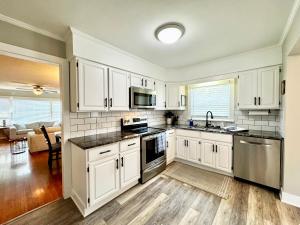a kitchen with white cabinets and a counter top at Hawks Nest in Marion