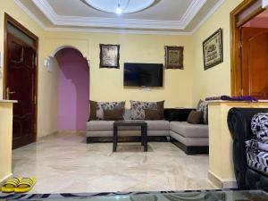 a living room with a couch and a tv at Souhail house in Chefchaouen