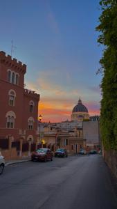 a city street with cars parked in front of a building at ROMAN DREAM I in Rome