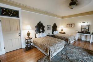 a hotel room with two beds and a door at Castaneda Hotel in Las Vegas