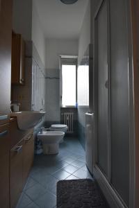 a bathroom with a toilet and a sink at Traiano 49 in Turin +22 photos
