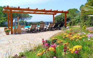 A garden outside Alghero Villa Barranch with sea view swimming pool for 6 people
