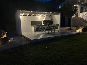 a table and chairs on a patio at night at La Casa Tzortzina in Kokkino Nero