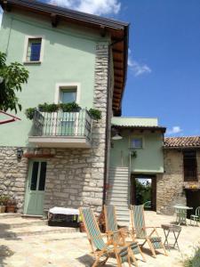 two lawn chairs sitting in front of a building at La Corte del Borgo in Valverde Pavia