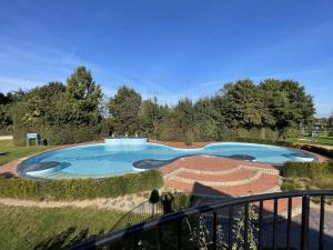 a view of a swimming pool from a balcony at Marina Strandbad Chalet Wasserwelt Haus Nr 32 in Olburgen