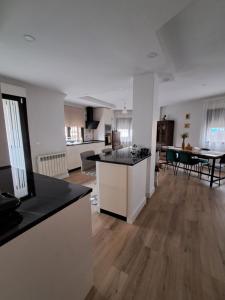 a living room with a kitchen and a dining room at El Rincon La Roca in El Espinar