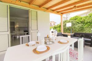 a white table and chairs on a patio at Villa Agata - Sea Life in Acquedolci