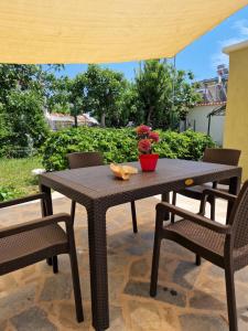 a wooden table and chairs on a patio at Sun & Salt Keramoti in Keramoti