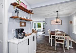 a kitchen and dining room with a table and chairs at Modern 3Bed Home Near CLE With Private Backyard in Parma Heights