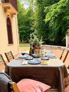 a table with plates and wine glasses on a patio at Lake House by Veneto Villa in Villa Osti