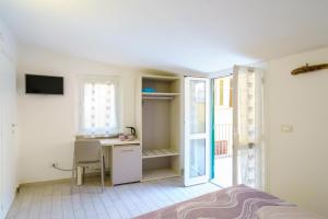 a bedroom with a desk and a bed and a window at OltreMare in Riomaggiore +46 photos