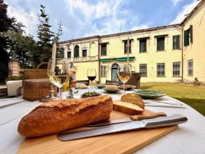 a table with bread and glasses of wine on it at Wisteria Lodge by Veneto Villa in Albignasego