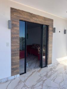 a sliding glass door in a room with a couch at Departamento Puerto Esperanza in La Porteña