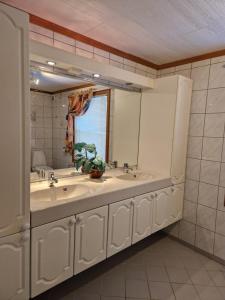 a bathroom with two sinks and a large mirror at Selnestun in Selnes +26 photos