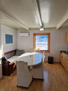 a kitchen and dining room with a table and chairs at Selnestun in Selnes