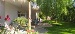 a garden with a tree and a house at Beach & Birds in Hohenfels