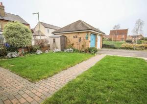 a house with a brick pathway in front of a yard at Private Room in Newmarket in Newmarket