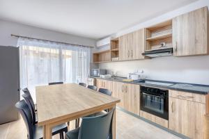 a kitchen with a wooden table and chairs at New! Spacious 4-Bedroom Duplex apt by SF Homes in Msida