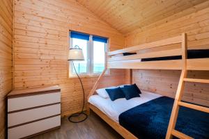 a bedroom with bunk beds in a wooden cabin at VIKING Gąski in Gąski