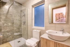a bathroom with a sink and a toilet and a shower at New! Spacious 4-Bedroom Duplex apt by SF Homes in Msida +33 photos