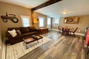 a living room with a couch and a table at Hoppy Hill Farm House in Dover Plains