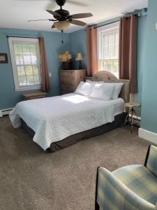 a bedroom with a bed and a ceiling fan at Hoppy Hill Farm House in Dover Plains
