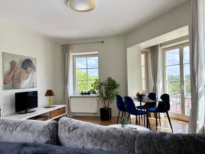 a living room with a couch and a table and chairs at Barbacan Apartments in the Old Town in Vilnius
