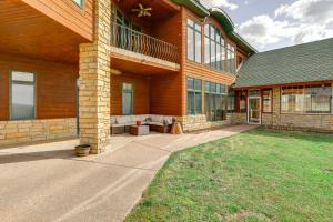 a large house with a porch and a patio at 366 Shared Acres, Lake Access: Ozark Getaway! in Fairfield Bay
