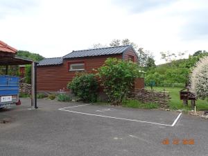 a house with a parking lot in front of it at Tiny-house in Wihr-au-Val
