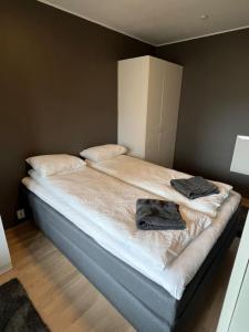 a bed with two towels on it in a bedroom at Staymate apartment at Lade in Trondheim