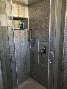 a shower with a glass door in a bathroom at Charming Town House, Limani 9 in Mirina +9 photos
