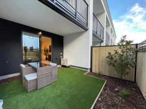 a house with a yard with green grass at Stylish and Lush CBD Studio in Christchurch