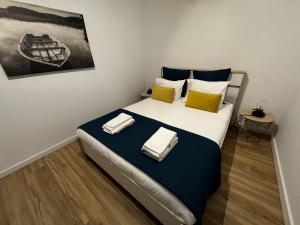 a bedroom with a bed with two towels on it at Sky & Ocean in Calheta +9 photos