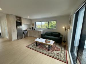 a living room with a couch and a coffee table at Relaxing CBD Getaway in Christchurch +5 photos