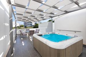 a hot tub on the balcony of a house at Agava Lux in Trogir