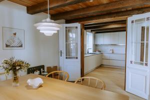 a kitchen and dining room with a wooden table at Tonis Traumhaus in Rietberg +27 photos