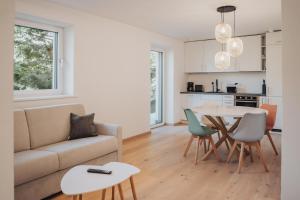 a living room with a couch and a table at Apart Suites Gravbach in Lagundo