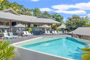 a swimming pool in front of a house at Cape Vue - Vue 5 Byron Bay in Ewingsdale